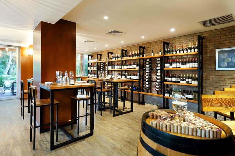 Wine tasting room with extensive bottle display shelves and wooden counters
