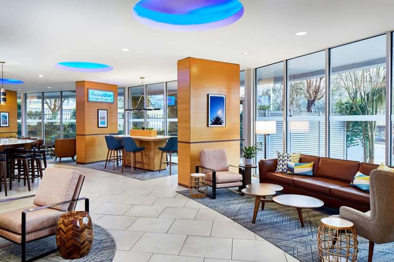 Modern hotel lobby with colorful ceiling lights and contemporary furnishings