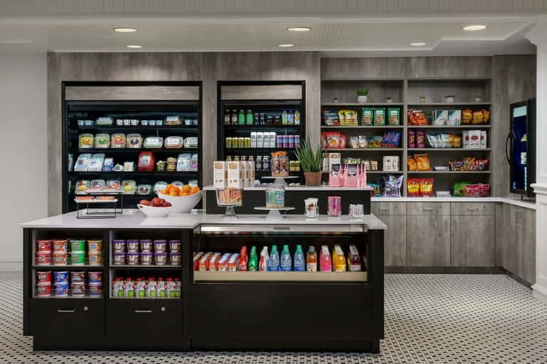 Modern convenience store interior with refrigerated displays, snacks, and organized shelving