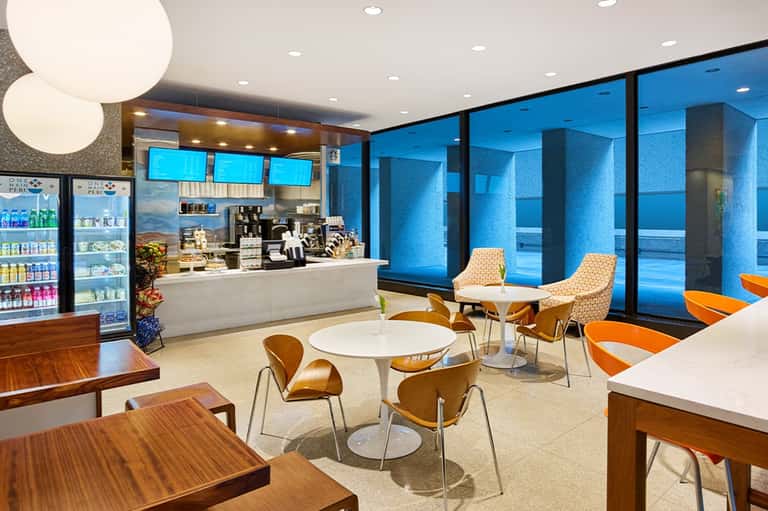 Modern resort cafe with ocean views, serving counter, and seating area