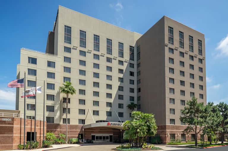 Mid-rise Marriott hotel exterior with brick and tan facade