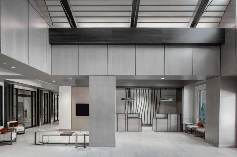Contemporary resort lobby with high ceilings, skylights, and modern furnishings