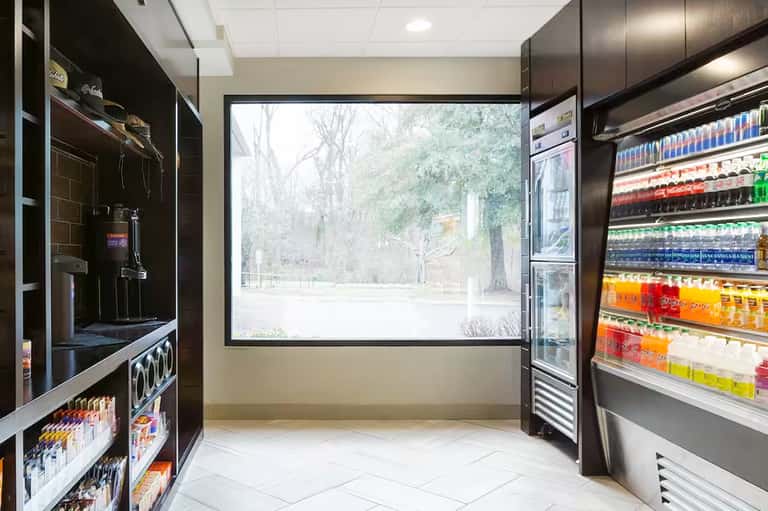 Resort beverage station with refrigerated cases, ice machine, and large windows
