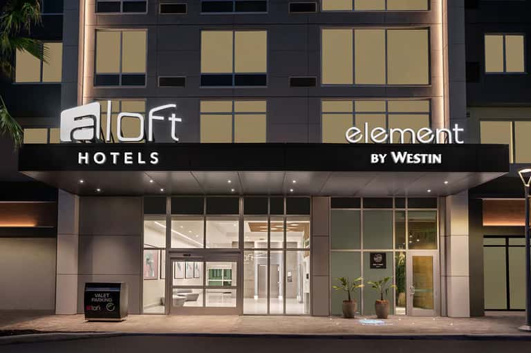 Aloft Element by Westin hotel exterior with modern black and tan façade and glass entrance