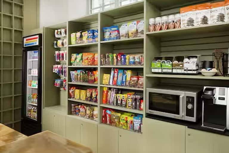 Well-stocked convenience pantry with snacks, beverages, microwave, and refrigerator