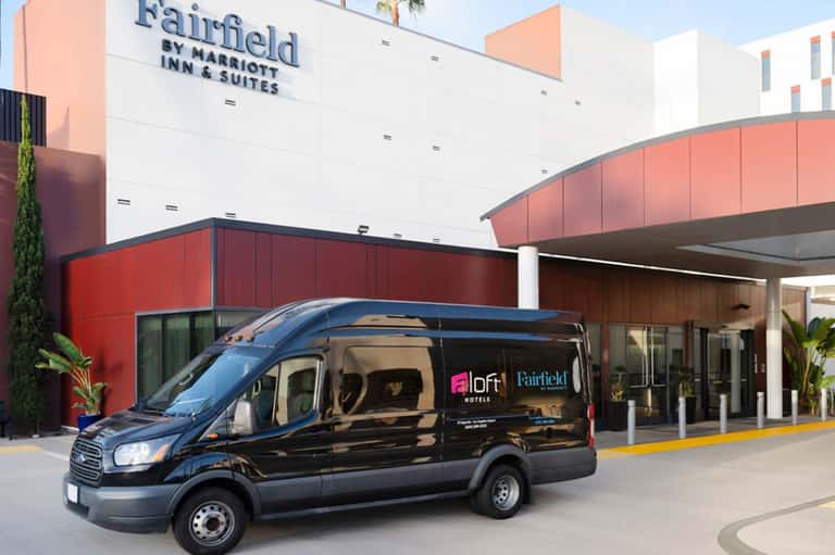 Black shuttle van parked at Fairfield by Marriott Inn & Suites entrance