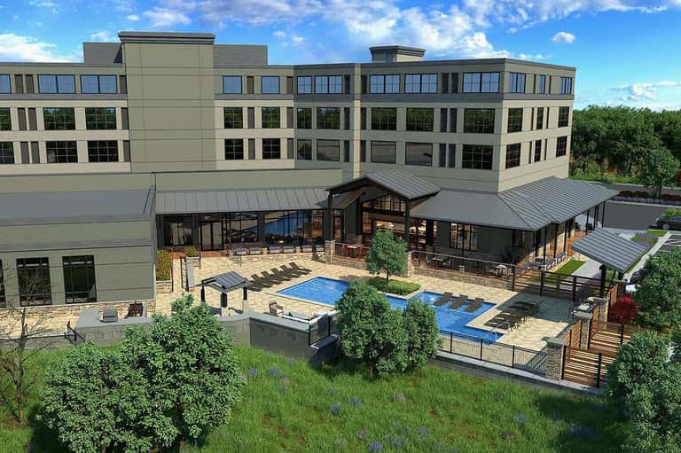 Architectural rendering of modern resort with multiple buildings, pool, and landscaped grounds