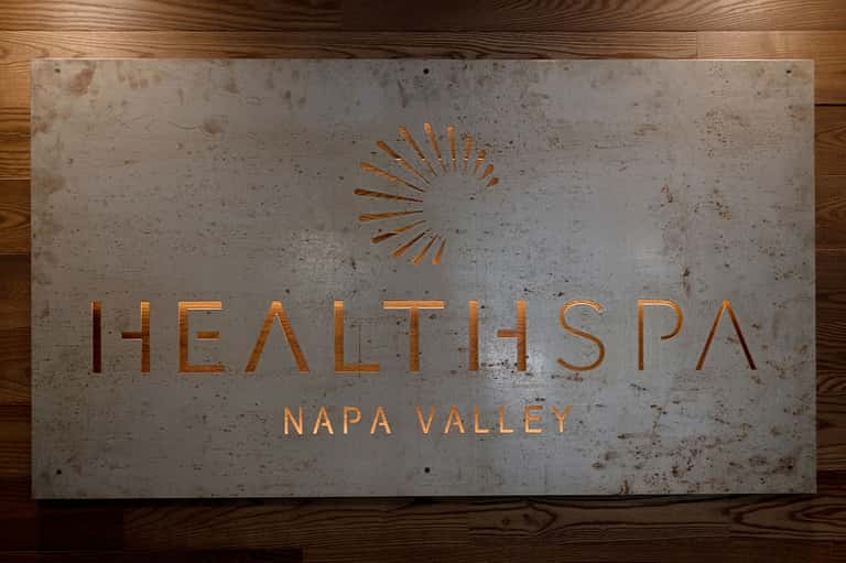 Health Spa Napa Valley sign in concrete and copper on wooden floor