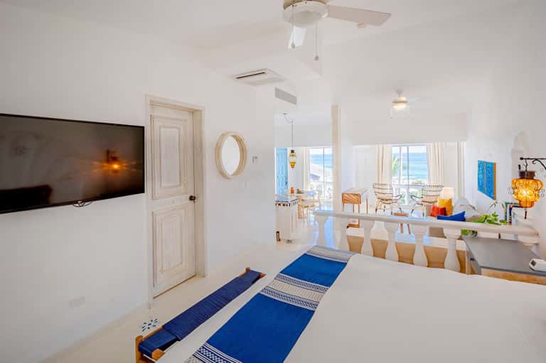 Modern resort suite with ocean views, blue runner rugs, and contemporary furnishings