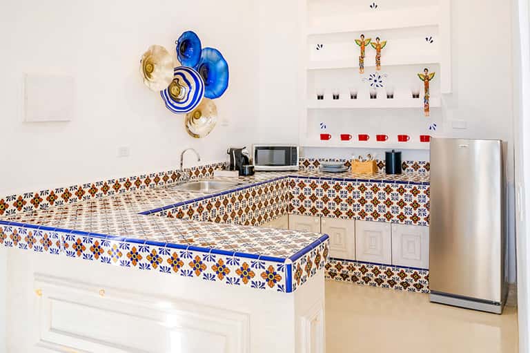 Resort kitchen with decorative blue-trimmed counters and colorful wall plates