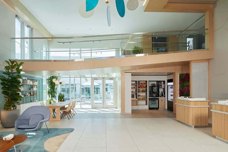 Modern spa reception area with two-story wood-trimmed interior and water views