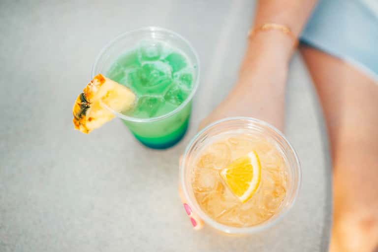 Colorful tropical cocktails with pineapple and lemon garnishes on a table
