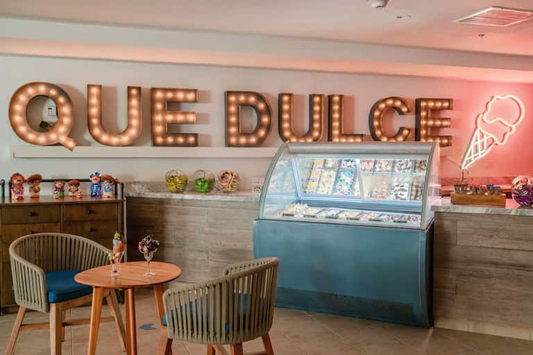 Retro-style ice cream parlor with vintage marquee sign and turquoise service counter