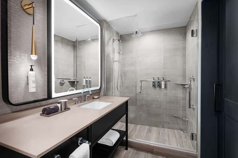 Modern bathroom with vessel sink, glass shower enclosure, and contemporary fixtures