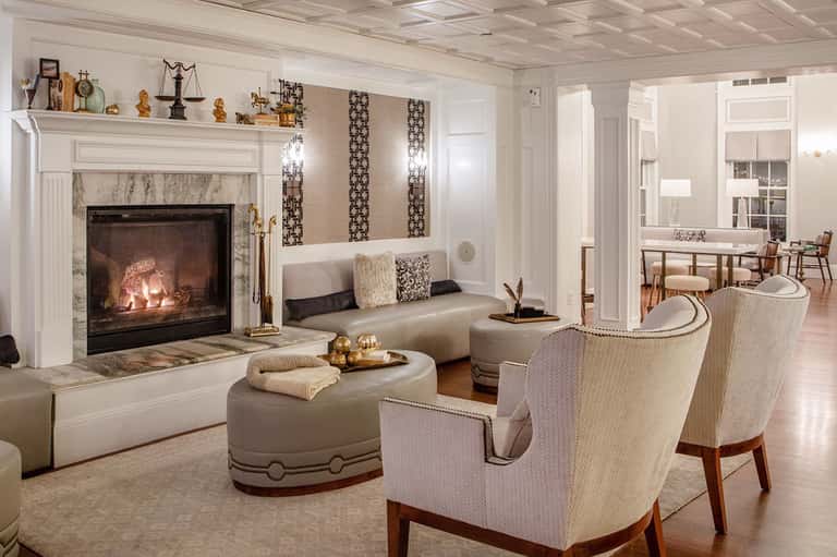 Luxury resort lounge with fireplace, elegant seating, and classic interior design