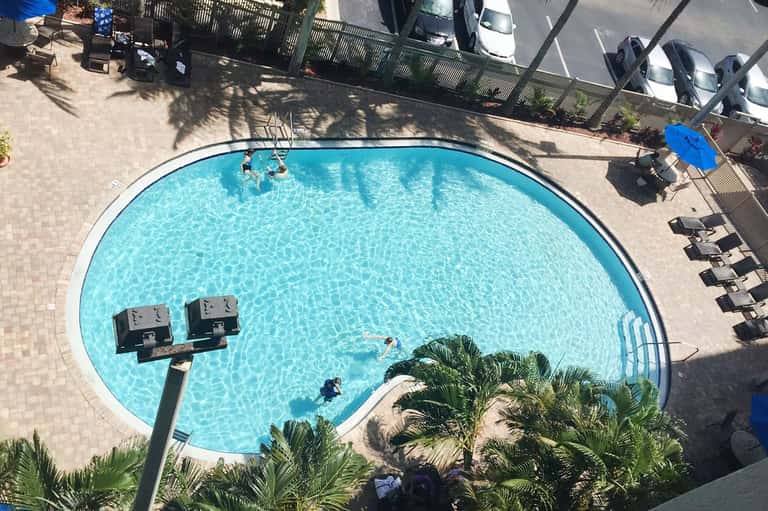 Circular blue pool with lounge chairs viewed from above