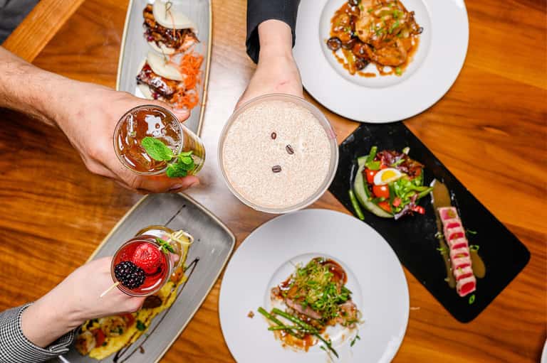 Fine dining table with plated dishes and beverages at an upscale restaurant