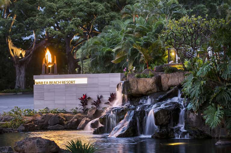 Wailea Beach Resort sign with waterfall and tropical landscaping