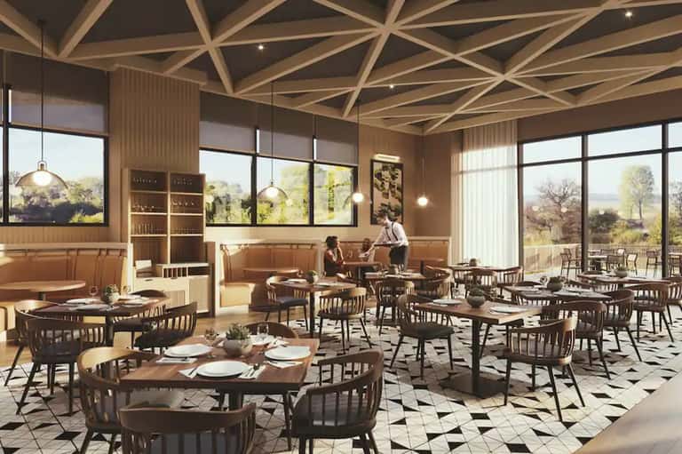 Modern restaurant interior with wooden ceiling beams, dining tables, and large windows overlooking landscape