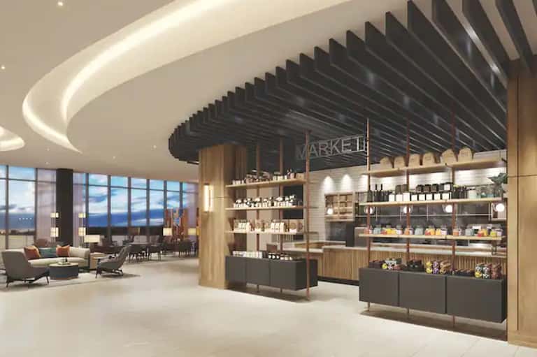 Contemporary hotel lobby with curved ceiling, market marketplace counter, and ocean views
