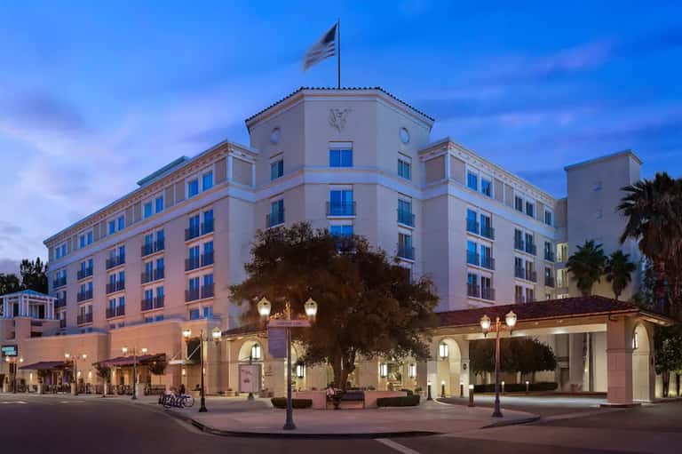 Historic hotel building lit at twilight with classical architecture and entrance