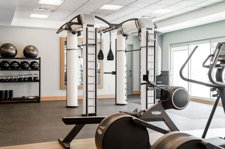 Modern fitness center with strength training equipment, free weights, and exercise machines