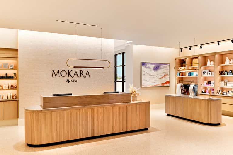 Elegant spa reception desk with MOKARA SPA signage and wood interior design