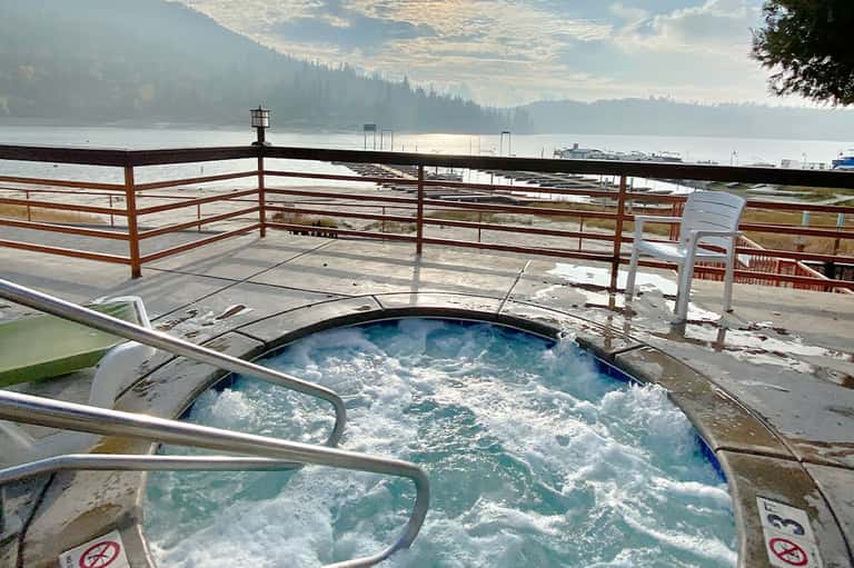 Hot tub overlooking scenic mountain lake and forested shoreline
