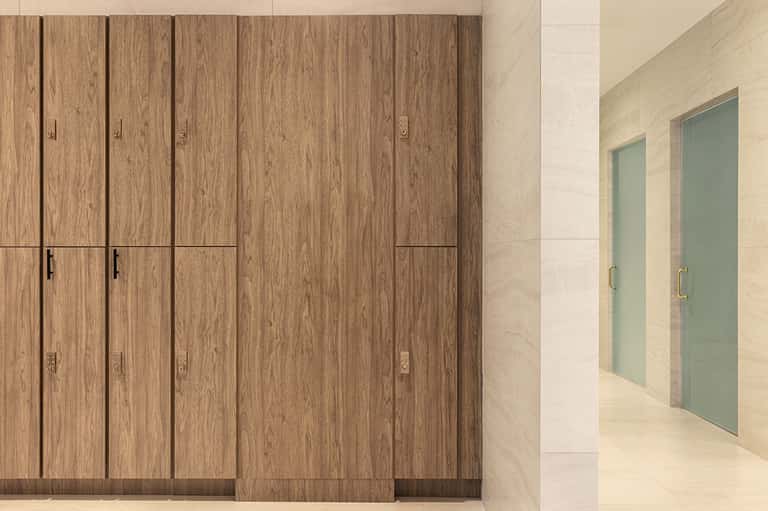 Interior corridor with wooden wardrobe cabinets and frosted glass bathroom doors