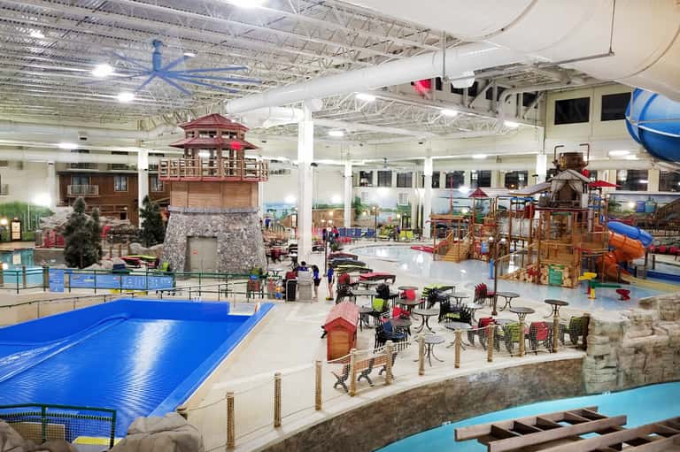 Indoor water park with pools, water slides, climbing structures, and play areas
