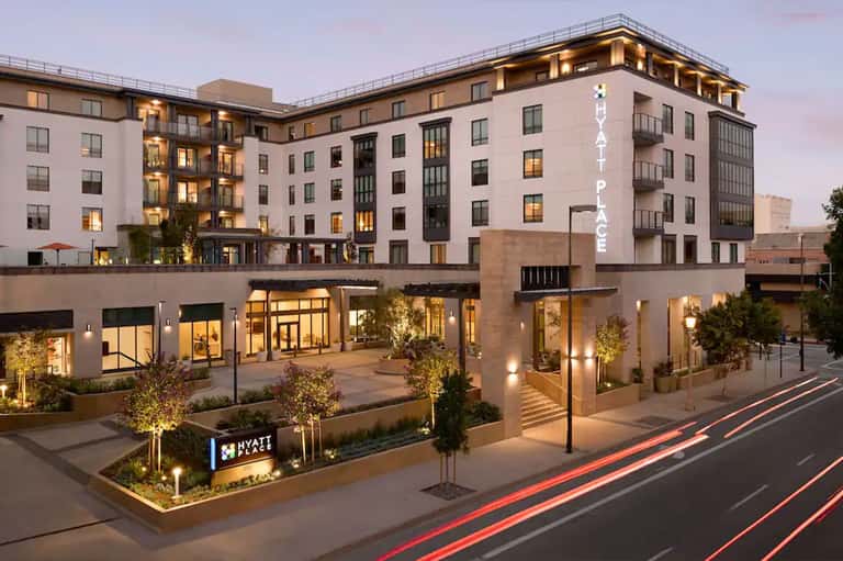 Hyatt Place hotel exterior with illuminated signage and courtyard at twilight