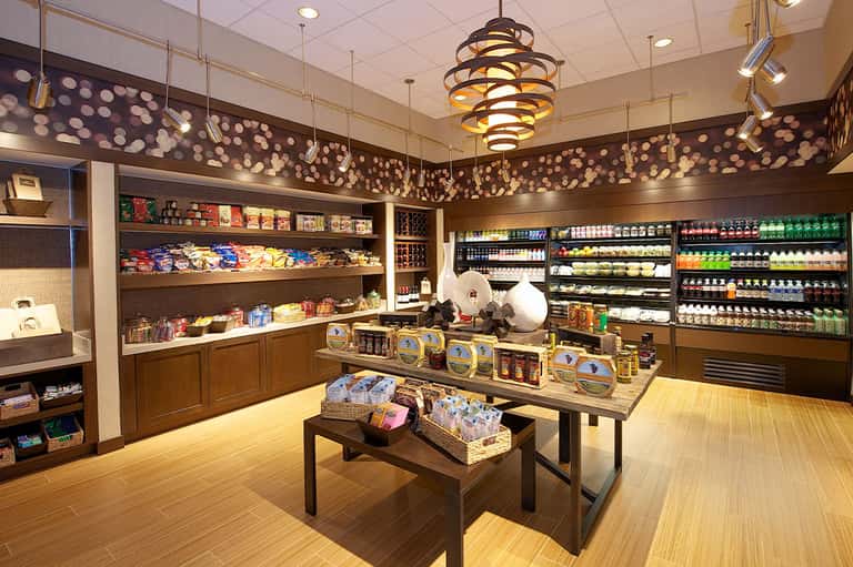 Modern resort convenience store with shelving, refrigerated goods, and products display