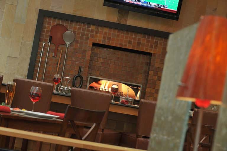 Modern fireplace lounge area with brown leather seating and mounted television