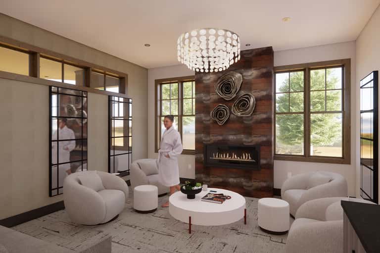 Modern spa lounge with curved cream seating, fireplace, crystal chandelier, and large windows