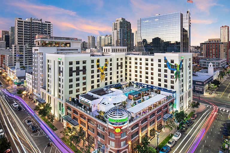 Urban rooftop pool and lounge at modern city hotel with skyline views and colorful art installations