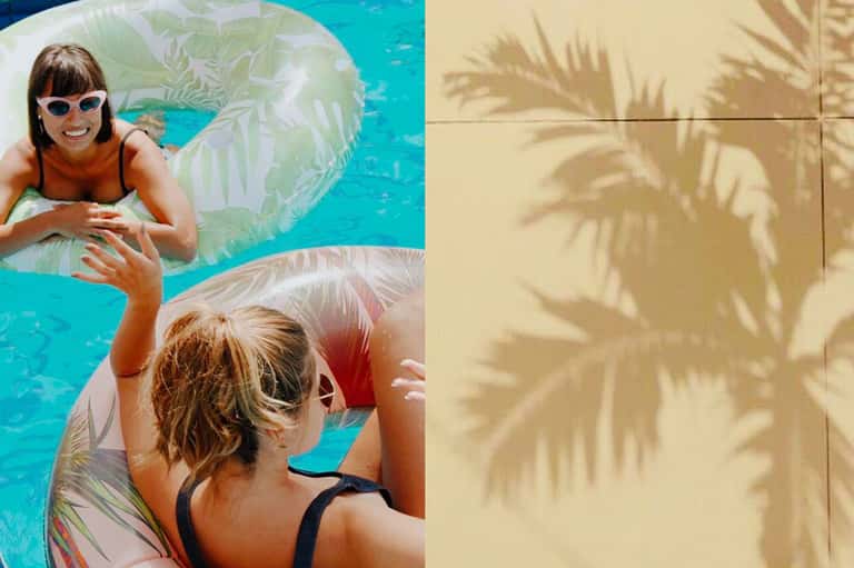 Two guests on inflatable floats in bright turquoise pool water with palm tree shadows on deck