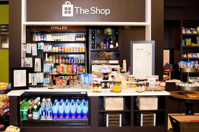 Resort shop counter displaying beverages, snacks, and retail merchandise