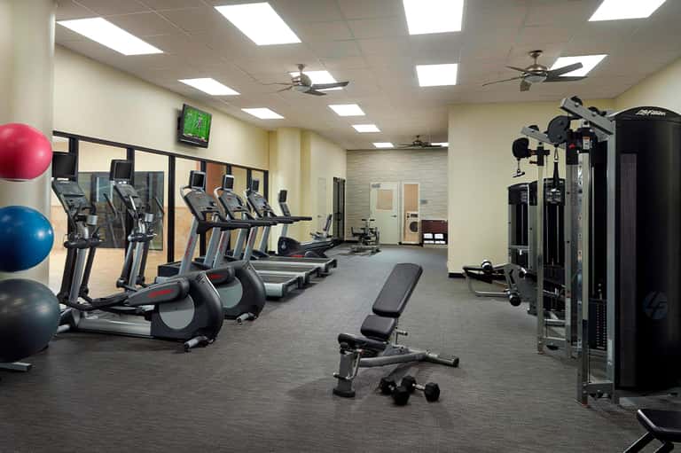 Fitness center with cardio equipment, treadmills, exercise machines, and fitness amenities