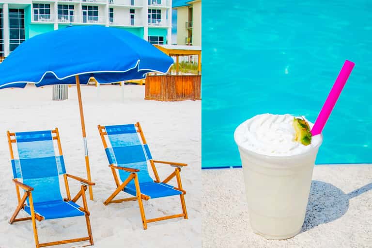 Beach chairs and blue umbrella on white sand with tropical drink and turquoise ocean water
