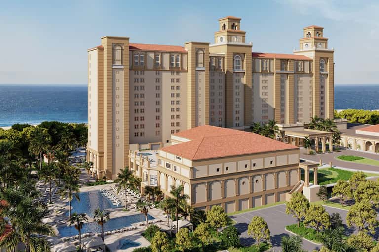 Beachfront luxury resort towers with Mediterranean architecture and ocean backdrop