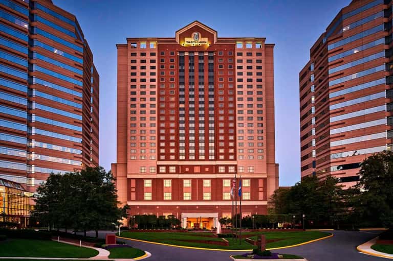 Large red brick casino hotel tower at dusk with surrounding residential high-rises