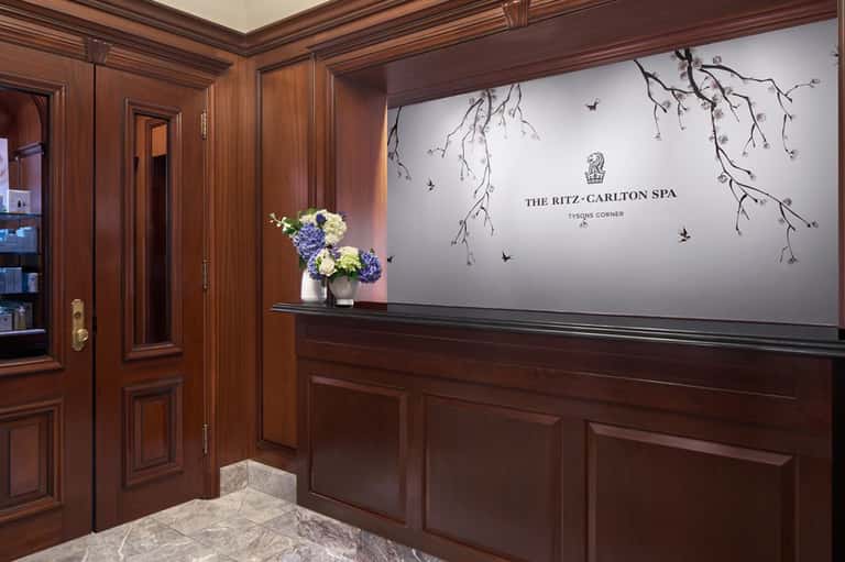 Ritz-Carlton Spa entrance with mahogany paneling, flowers, and elegant signage at Tysons Corner