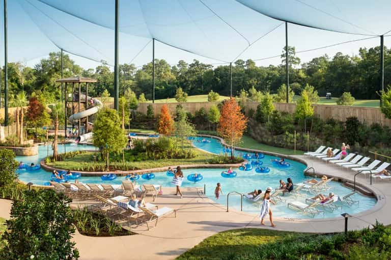 Family water park with lazy river, pools, waterslide, and covered seating areas