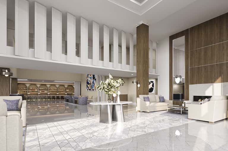 Modern luxury hotel lobby with marble floors, contemporary seating, and double-height spaces