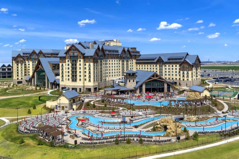 Aerial view of large castle-style resort with multiple pools and manicured grounds