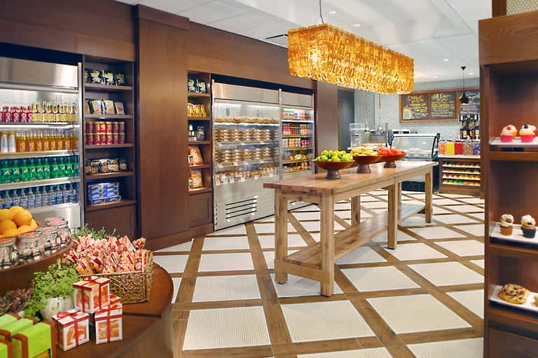 Modern bakery and café interior with wood display cases and fresh pastries on counter