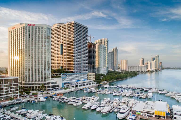 Waterfront resort with Marriott hotel, high-rise buildings, and marina filled with boats