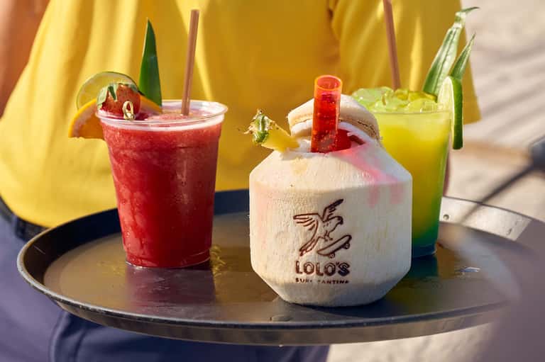 Tropical cocktails served at a resort bar with coconut drink and colorful beverages