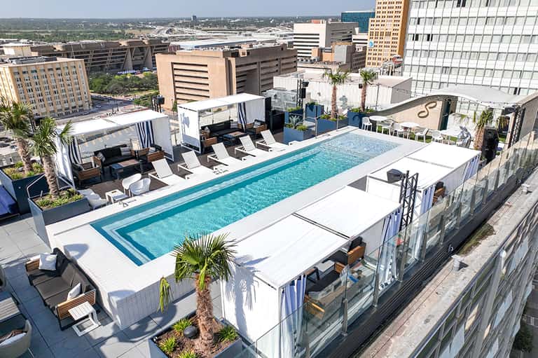 Modern rooftop pool on high-rise building with city skyline and river views