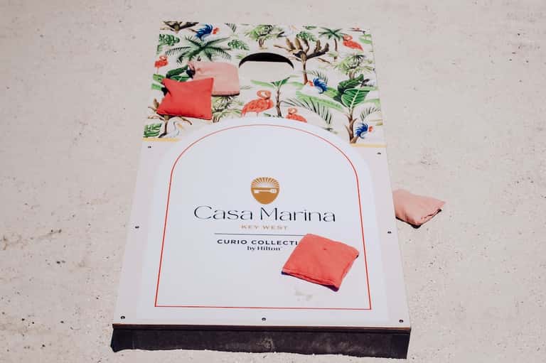 Cornhole board game with tropical bird design at Casa Marina Key West resort beach